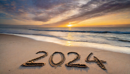 New year, 2024 written in sand on a beach during soft sunset.