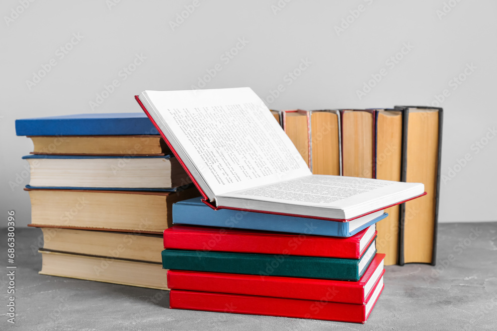 Open and closed books on grey grunge table