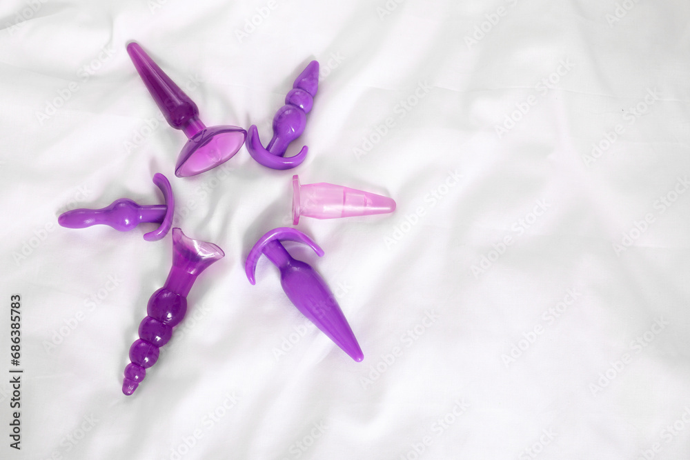 Anal plugs on white blanket, top view