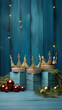 Three golden crowns with festive Christmas decoration on a light blue worn wooden background, the three wise men concept