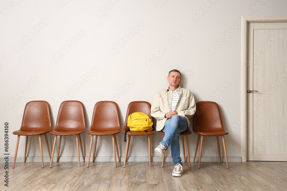 mature man waiting for his turn in room