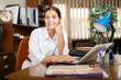 © JackF - Positive secretary girl works at a computer in a well-lit office, sitting at the workplace