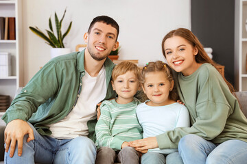 Sticker - Little children with their parents sitting on sofa at home