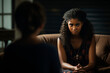 © Hanna Haradzetska - Dark-skinned sad teenage girl shares her traumas with a psychologist