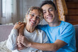 Portrait of grateful teenager man hug smiling middle-aged mother show love and care, thankful happy grown-up son in embrace cheerful mom, enjoy weekend family time at home together, bonding concept.