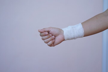 Wall Mural - Asian and African male hands with elastic bandages on white background. Wrist wound, bandage, hand wound, painkiller