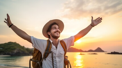 A Happy male traveler in hat and backpack raising arms on beach at sunset Delightful male traveler enjoying quiet time, travel and mental health.