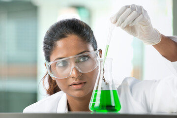 Woman scientist analyzing a solution.