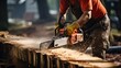 © afzar - Carpenter cutting a log with a chainsaw in his workshop