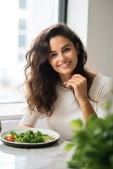 Wall Mural - A young woman eating behind kitchen table