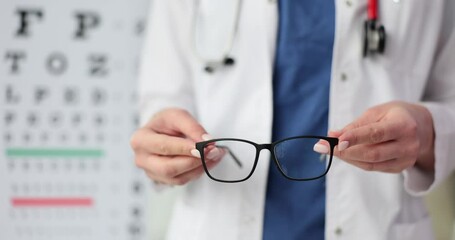 Canvas Print - Doctor hands give patient pair of black glasses