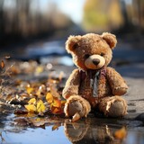 Fototapeta  - Dirty teddy bear toy lies outdoors on the road. AI Generated