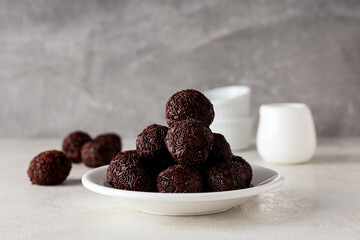 Wall Mural - Brigadeiro on plate on gray background, close up