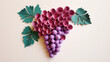 A grape made of paper. Origami fruits. Fruits paper cut. Paper craft art. Isolated color object on white background