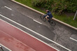© nuclear_lily - Man riding on bicycle on a bike path in the city. View from above.