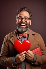 Portrait of a happy  man with a red heart  on Valentine's day concept.