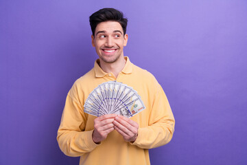 Sticker - Photo of funky dreamy man dressed yellow shirt rising dollars fan looking empty space isolated purple color background