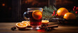 Mulled wine with spices on a wooden background.