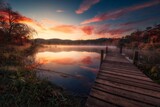 Fototapeta Las - Wooden dock extending out into a scenic river, surrounded by lush green trees at sunset