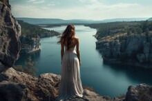 Woman On A Cliff With A Huge Lake In The Background