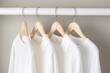 Wooden hangers with t-shirt white in wardrobe