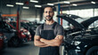 © BlazingDesigns - Auto car repair service center. Happy mechanic standing by the car.