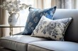 Close up of fabric sofa with blue and silver pillows. French country home interior design of modern living room