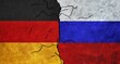 Germany and Russia flag together on a cracked wall. Diplomatic relations between Russia and Germany