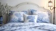 A bed with blue and white bedding and pillows