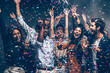 © gstockstudio - Group of joyful young friends dancing and enjoying celebration in night club while confetti flying around