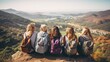 A group of female friends with backpacks sitting together on a mountain edge, overlooking a scenic valley and coastline, enjoying the view on a sunny day.