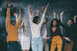 © gstockstudio - Group of young happy people dancing and throwing confetti while having fun in night club together