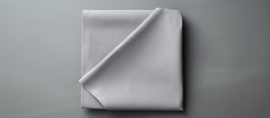 Wall Mural - Gray kitchen napkin isolated on table folded cloth for mockup on a flat lay Copy space image Place for adding text or design
