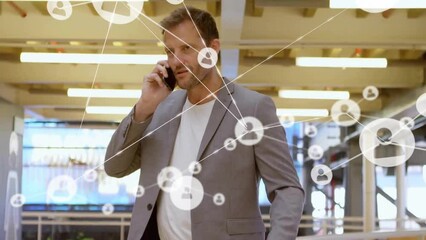 Poster - Animation of network of connections with icons over caucasian businessman using smartphone
