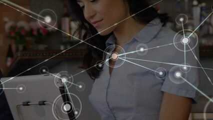 Poster - Animation of network of connections with icons over caucasian woman using tablet