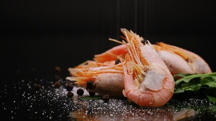 Wall Mural - boiled shrimp with spices on black background