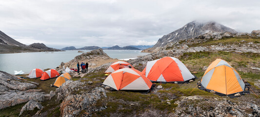 greenland, sermersooq, kulusuk, schweizerland alps, group of people at camp