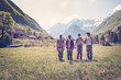Slovenia, Bovec, four anglers standing on meadow near Soca river