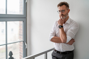 Wall Mural - Portrait of businessman at the window in office