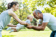© tunedin - Senior man spending time with his adult daughter and his granddaughter in a park