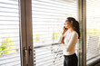 © tunedin - Woman on the phone looking out of the window