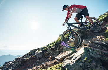 Wall Mural - Mountainbiker mountain biking against the sun in Grisons, Switzerland