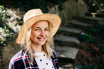 Wall Mural - Young blond woman with straw hat