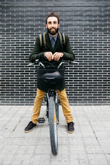 Sticker - Portrait of smiling man with e-bike at a brick wall