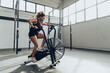 Young woman doing air bike workout in gym