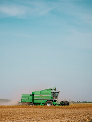 Wall Mural - Serbia, Vojvodina, Combine harvester in soybean field