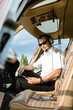 © tunedin - Portrait of pilot in cockpit of a helicopter