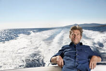 Portrait Of Content Mature Man On His Motor Yacht