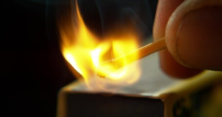 Wall Mural - match, fire and hand with burning flame on black background for heat, light and lighting wood in stu
