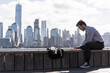 USA, man using tablet at New Jersey waterfront with view to Manhattan